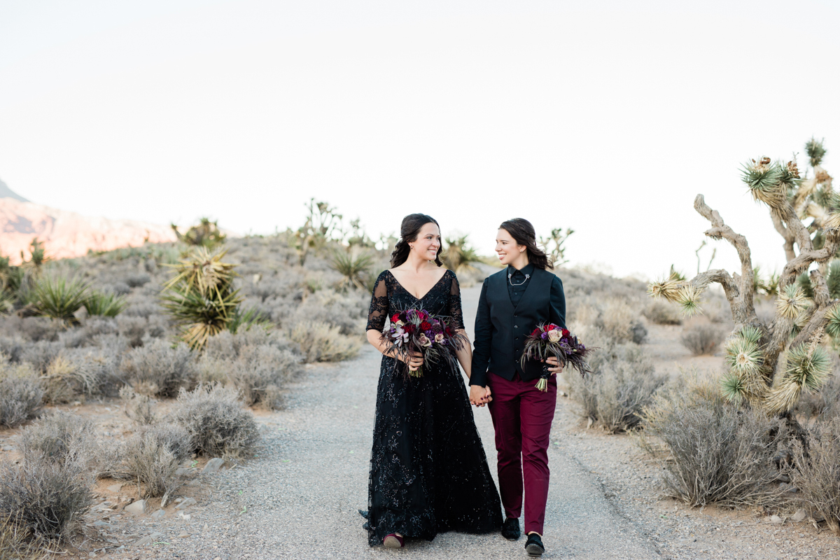 Bride walking in front of groom, holding his hand.