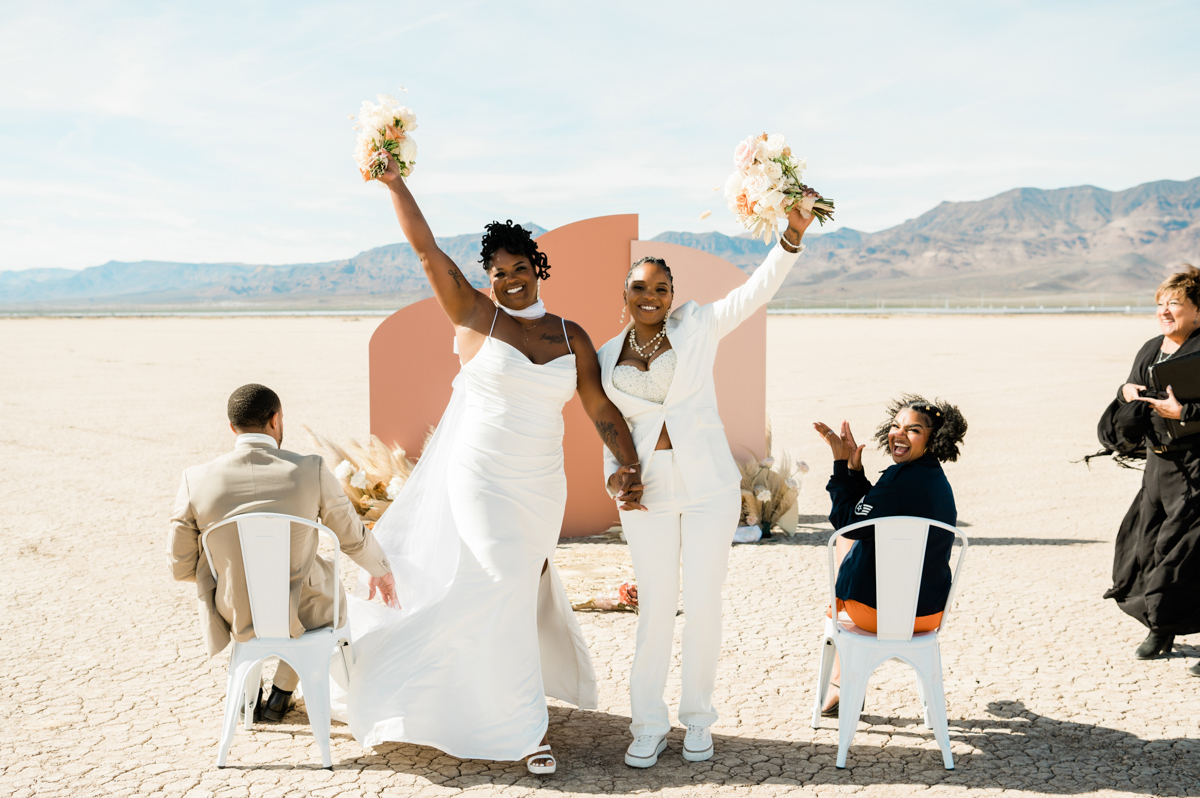 Newlywed couple opening champagne at mini reception.