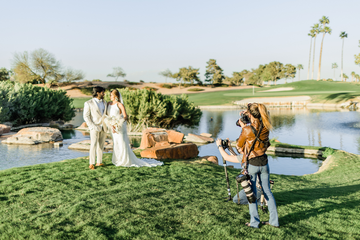 Bride and groom being photographed at country club.