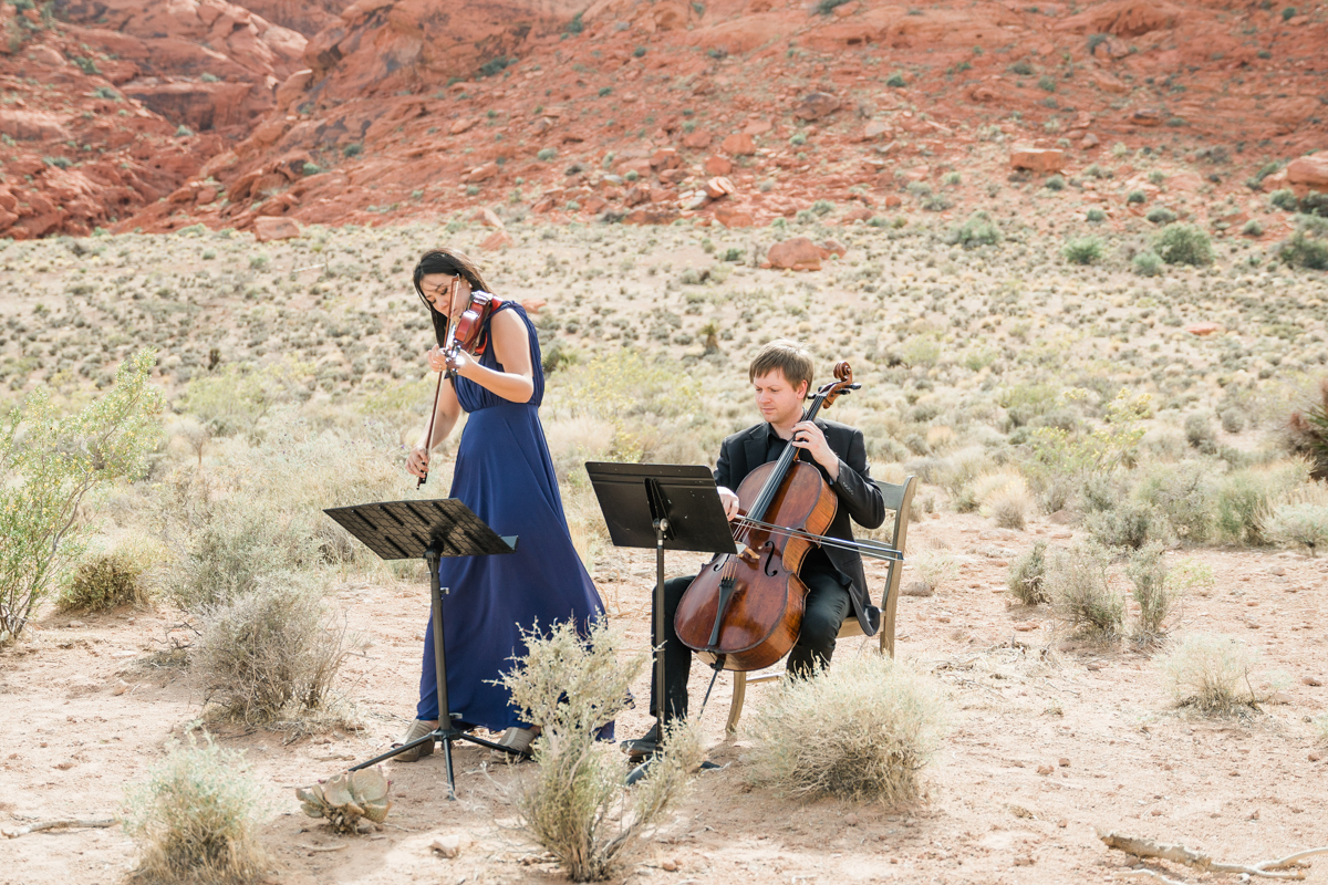 Musicians performing at a wedding in the desert.