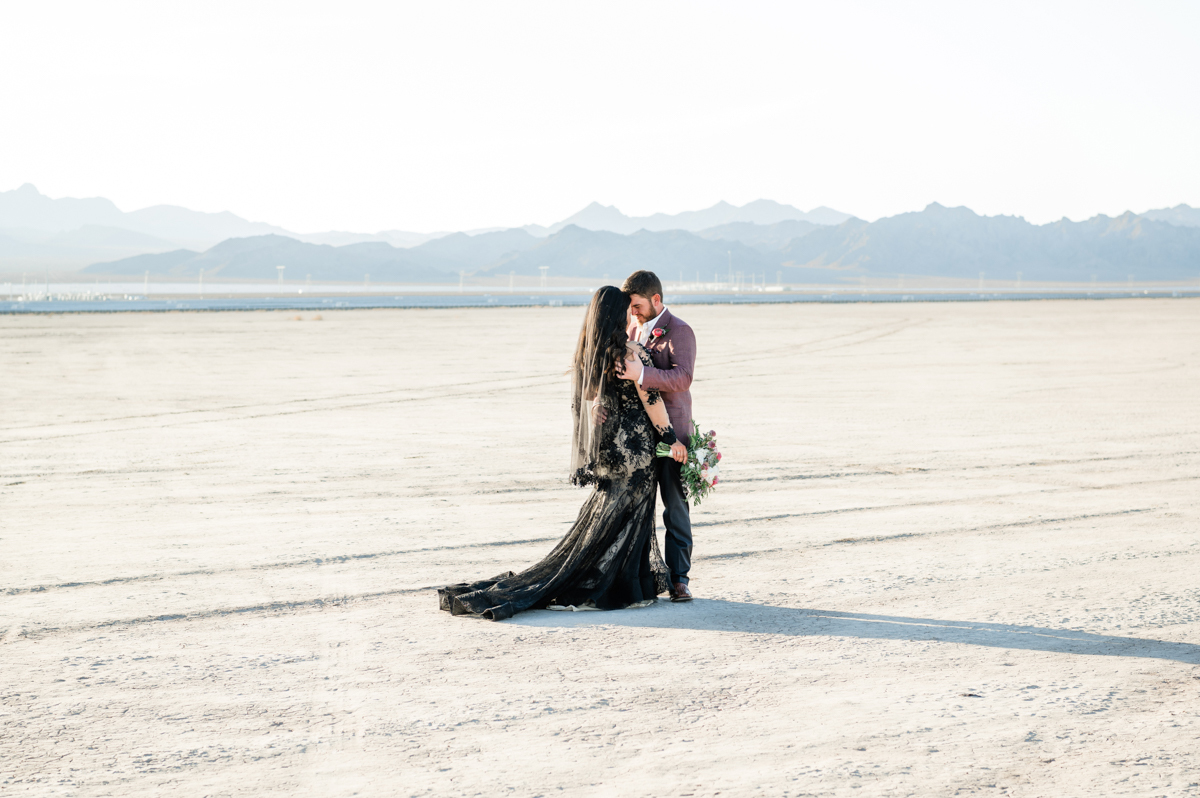 Bride and groom embracing in a wedding photo shoot outdoors.