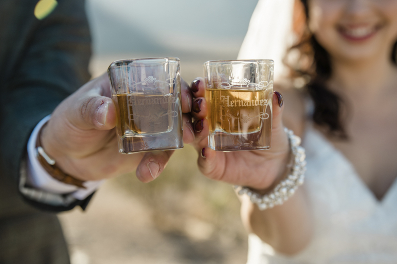Close up photo of alcohol filled monogramed shot glasses.