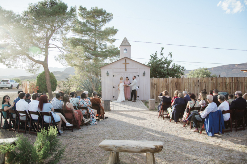 A wedding is taking place at Cactus Joe’s. There are about 40 guests seated in wooden chairs. A wedding is taking place at Cactus Joe’s. There are about 40 guests seated in wooden chairs.