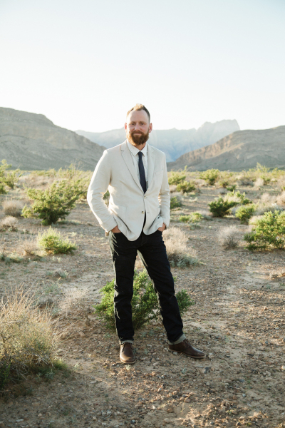 A full body portrait of a groom posing in the late afternoon sun in the Mojave Desert outside Las Vegas. A full body portrait of a groom posing in the late afternoon sun in the Mojave Desert outside Las Vegas.