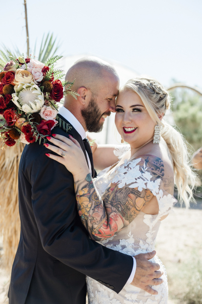 A groom and bride embrace on their wedding day at Cactus Joe’s Blue Diamond Nursery. A groom and bride embrace on their wedding day at Cactus Joe’s Blue Diamond Nursery.
