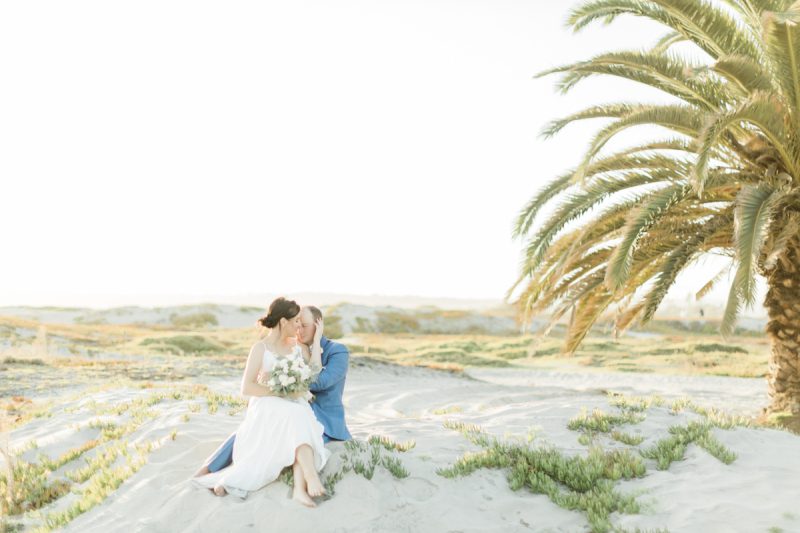 Couple sitting together on Coronado Beach.