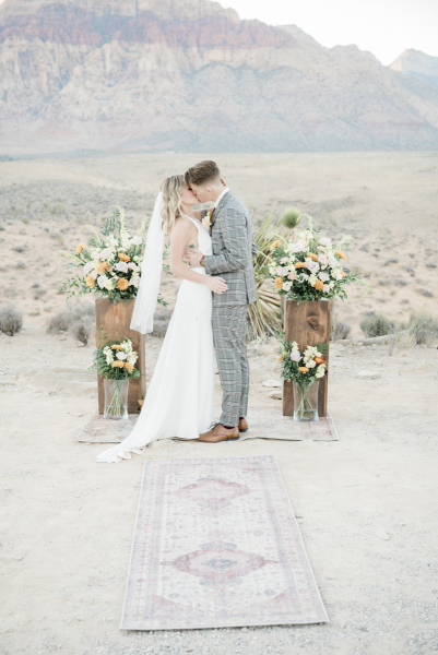 Bride and groom having ceremonial wedding kiss.