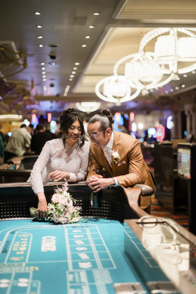 Bride and groom at casino table.
