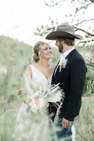 A couple looks lovingly at each other as they pose for wedding day photos in the Black Hills of South Dakota.