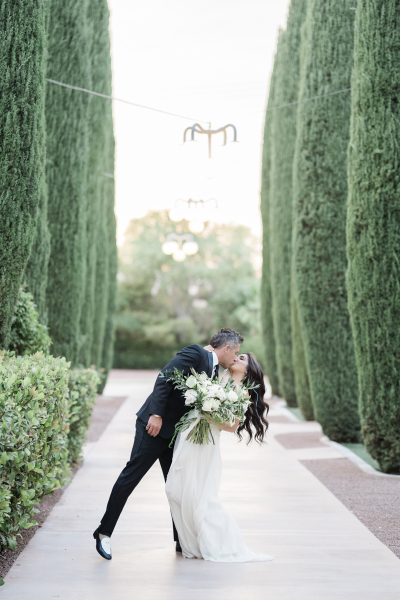 Groom dipping bride for a kiss.