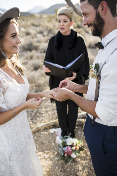 Close up of couple exchanging rings.