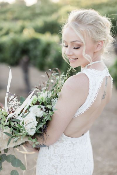 Bride is turned to side to show back of dress.