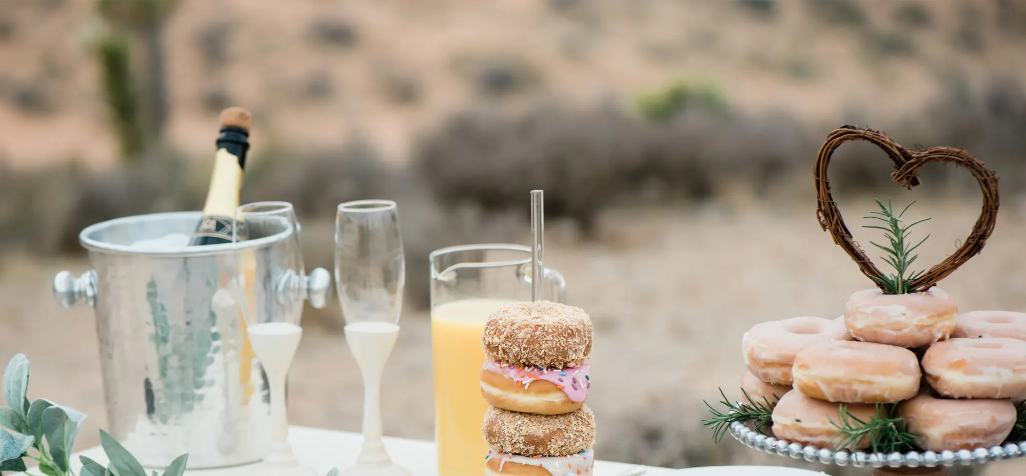 Champagne and donuts on wedding mini-reception table