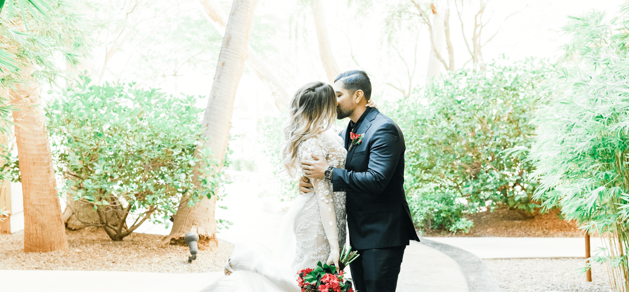 Newlywed couple kissing for photos at the Red Resort Hotel Casino.
