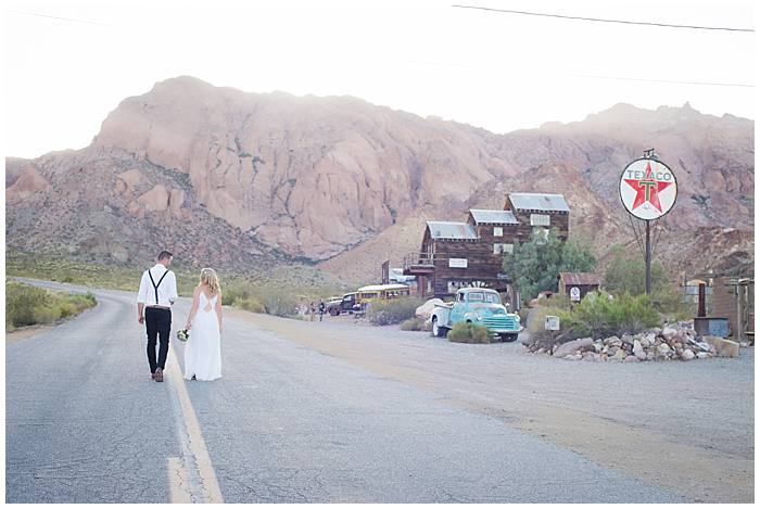 Couple walking in the road in an old ghost town.