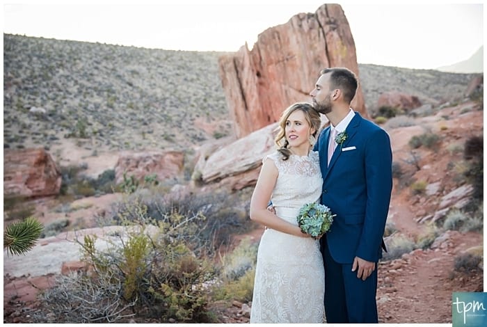 Couple standing side by side looking at the Red Rock Canyon landscape.