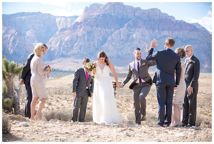 Couple walking down the aisle from a ceremony at Red Rock Canyon Overlook.