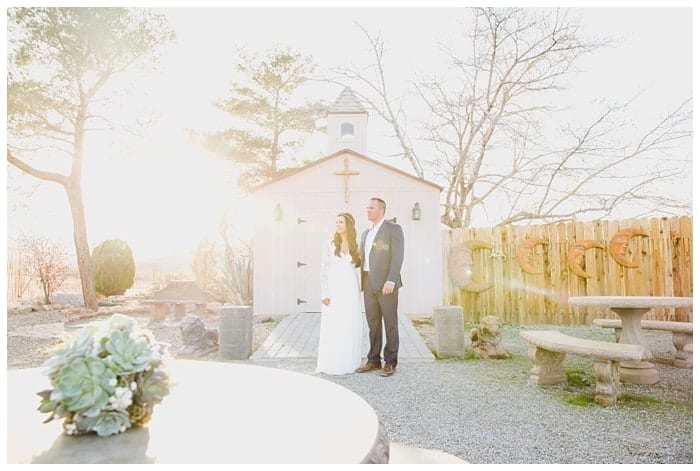 Couple standing in front of chapel at Cactus Joe's Nursery.