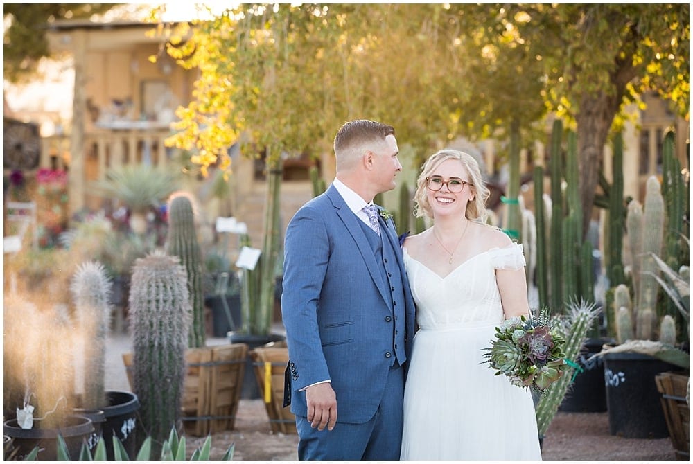 Bride and groom stand in front of cacti at Cactus Joe's.