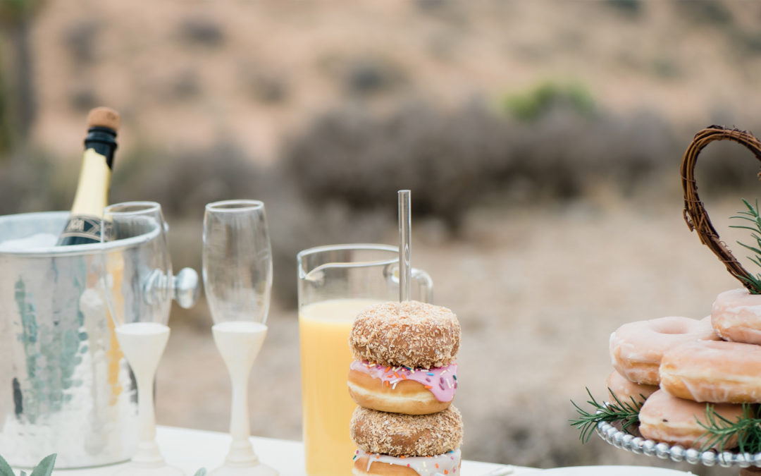 Champagne and donuts on wedding mini-reception table