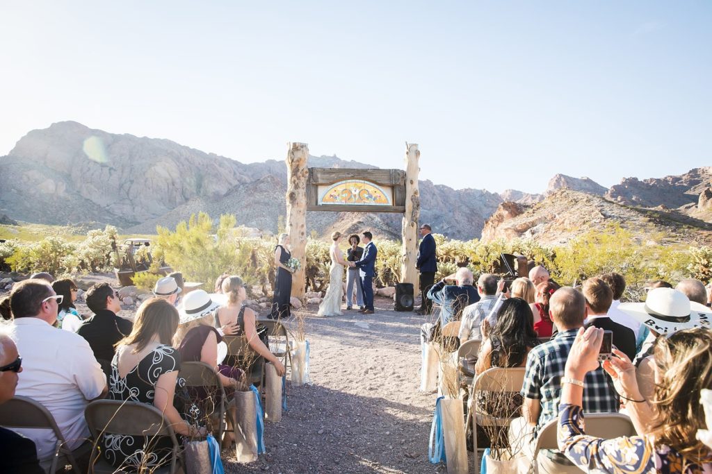 Bride and groom saying their vows at their micro wedding at Eldorado Dry Lake Bed.