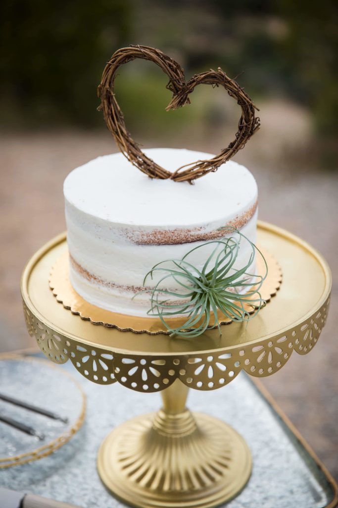 Mini wedding cake with heart topper.