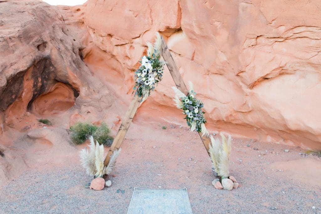 Wooden floral arbor for wedding ceremony.