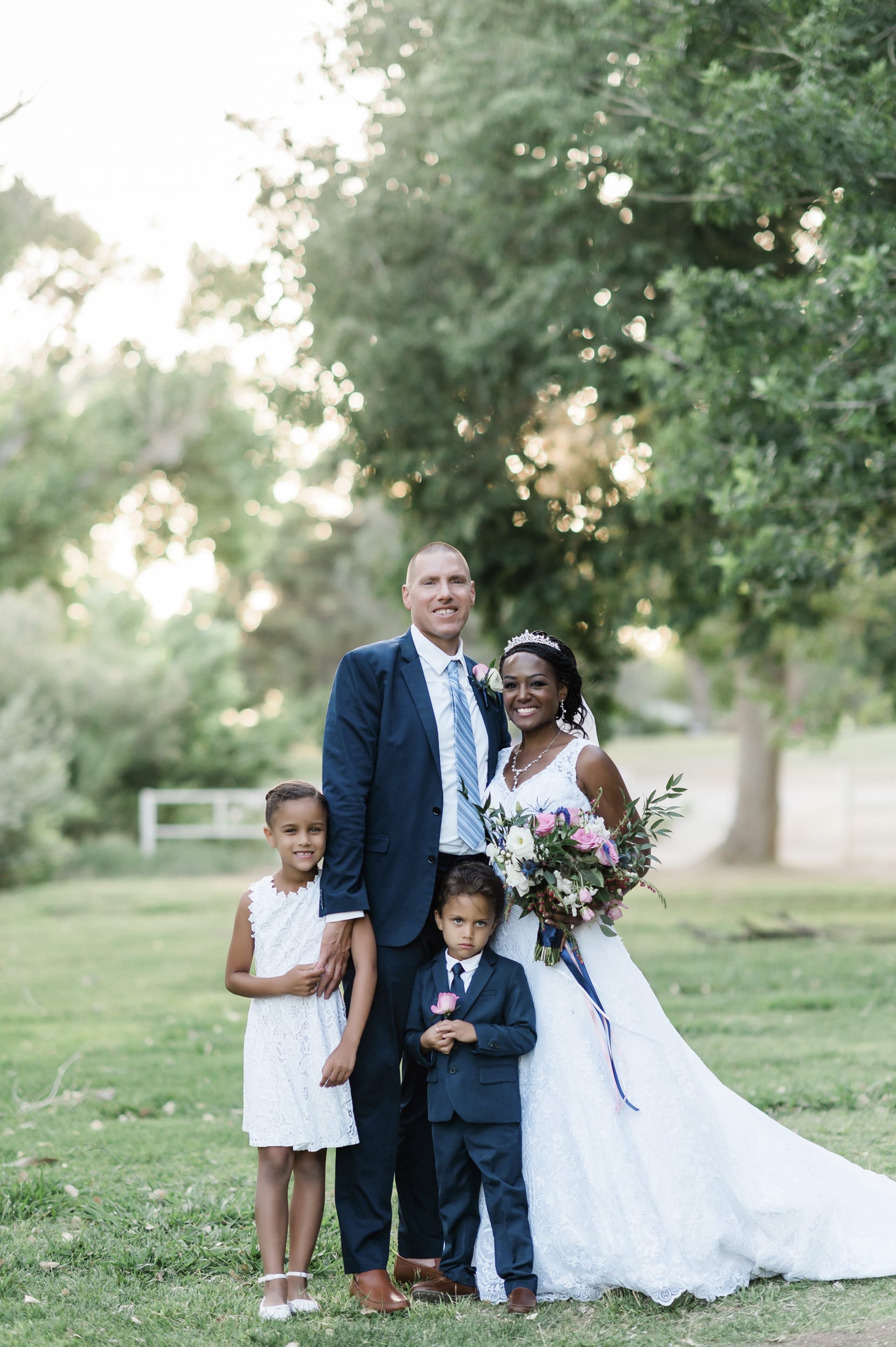 Latashia, Michael and family post at wedding.