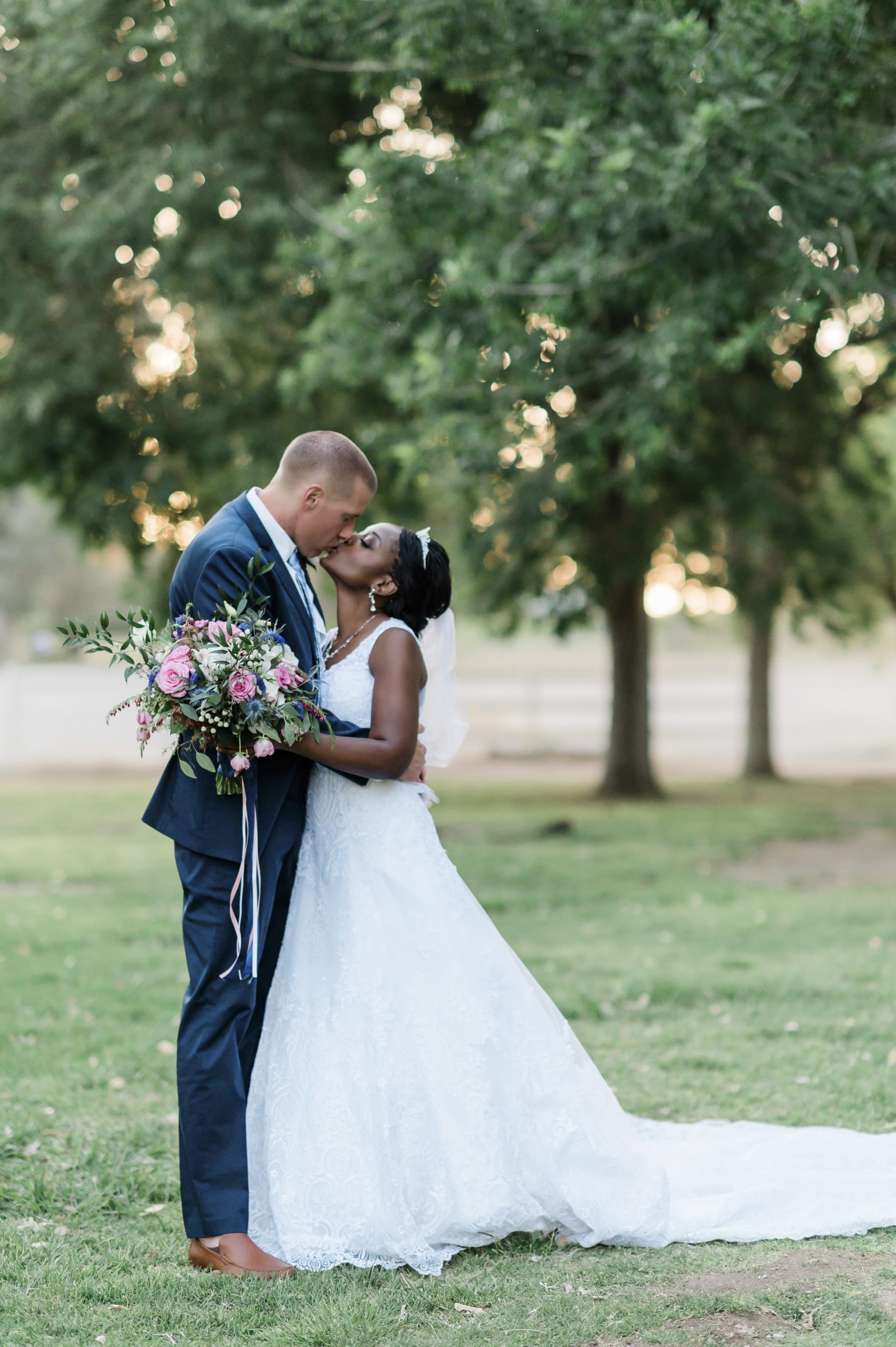 Latashia and Michael kissing for wedding photo.