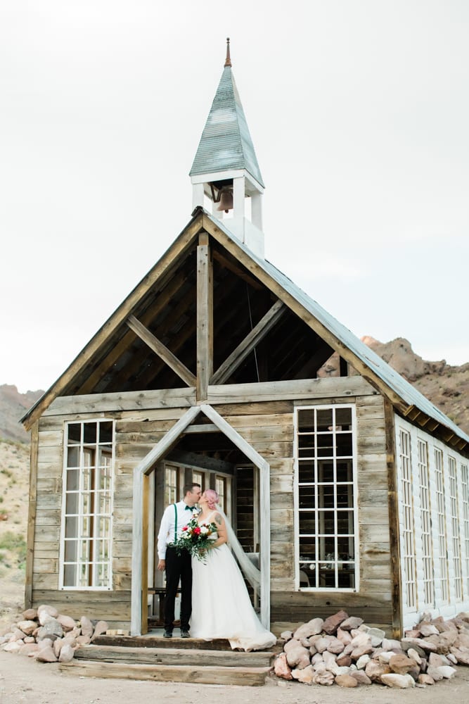 Hayley and Andrew kiss in front of the Eldorado Canyon Chapel.
