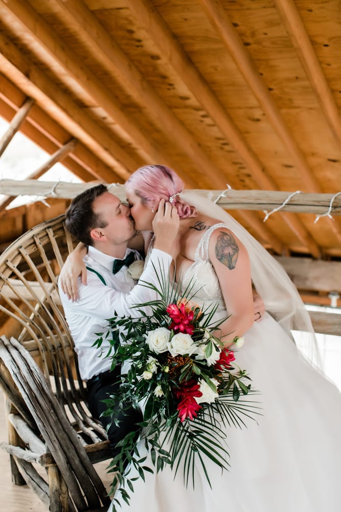 Hayley and Andrew kiss inside the antique barn at Eldorado Canyon.