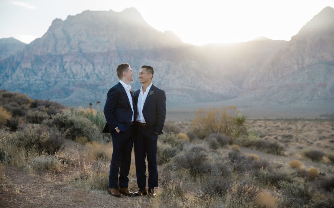 Two grooms at their minimony celebration in the Las Vegas desert.