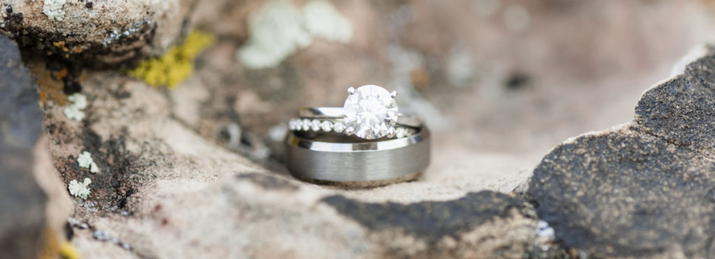 Wedding rings sitting on top of rock.