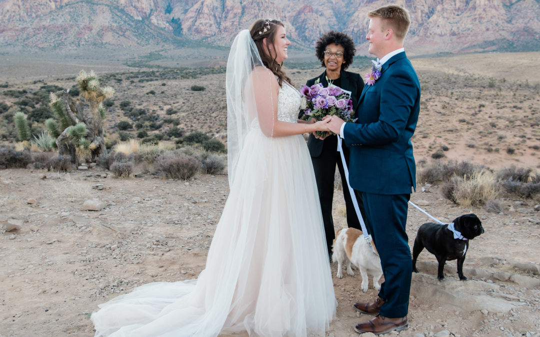 Bride and groom at their destination wedding ceremony with their pet dog at their side.