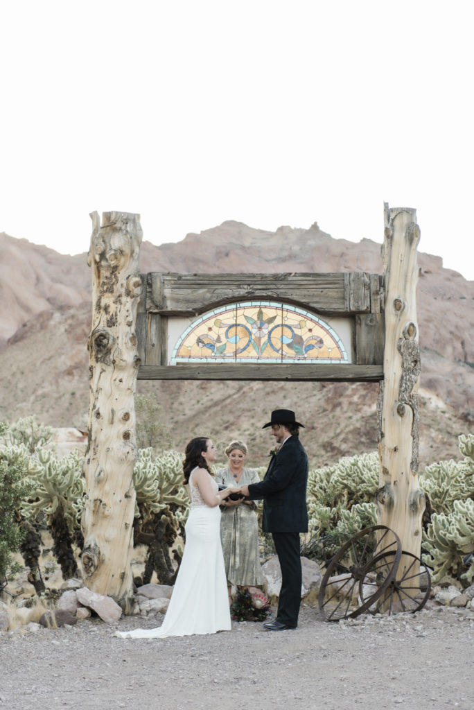 Ceremony in front of stained glass arch