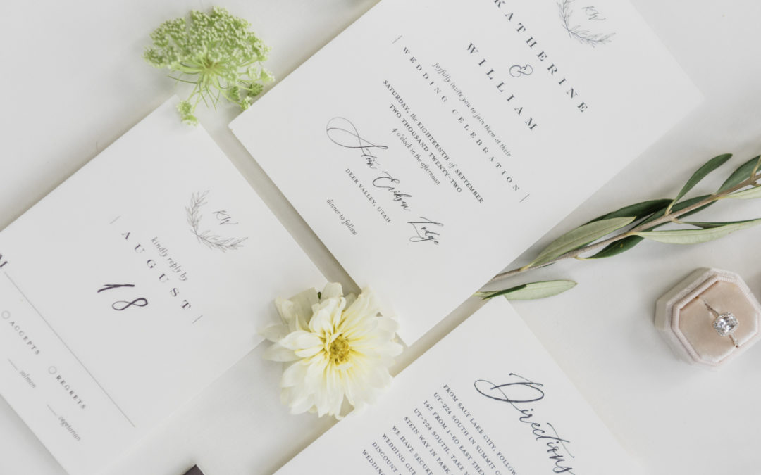 Flat lay of elopement announcement cards with flowers