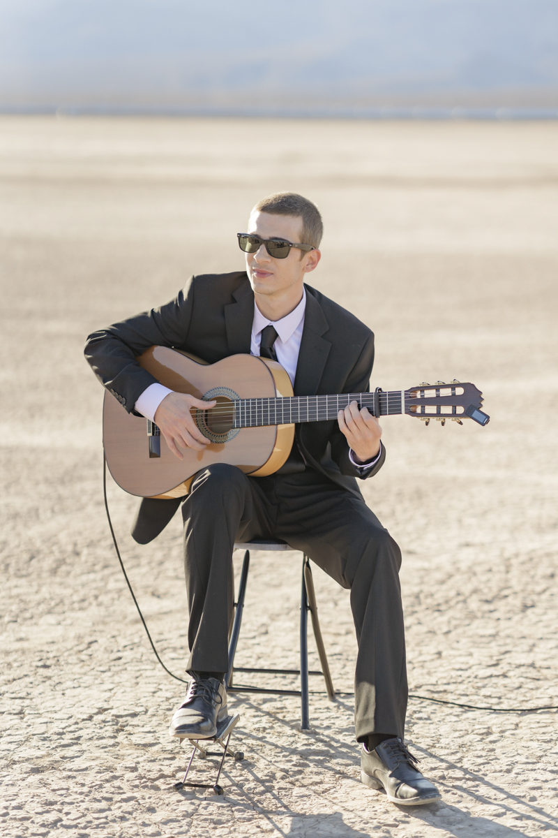 Man playing guitar at wedding.