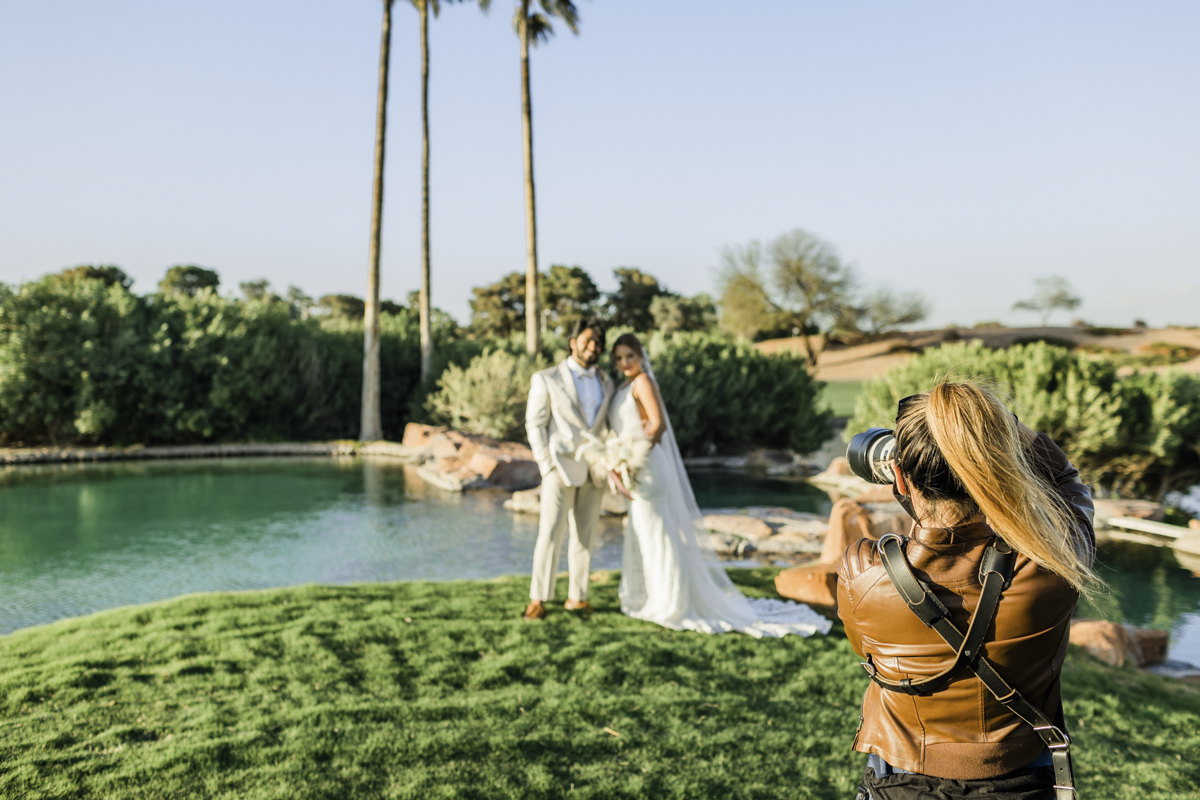 Behind the scenes photo of a photographer photographing the wedding couple.