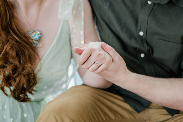 close up of engaged couple's hands