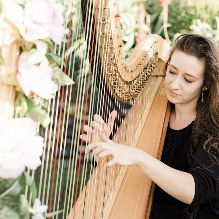 Woman playing harp.