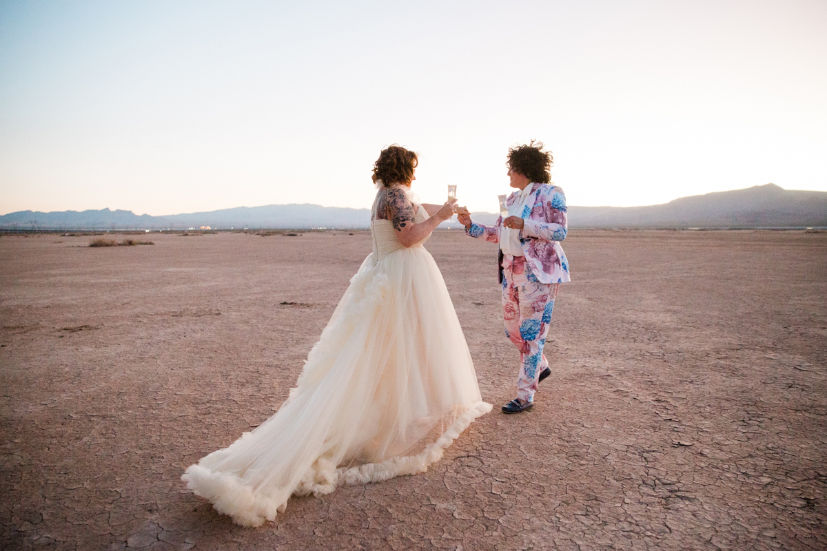 Newlyweds celebrating their destination wedding in Las Vegas with glasses of champagne.